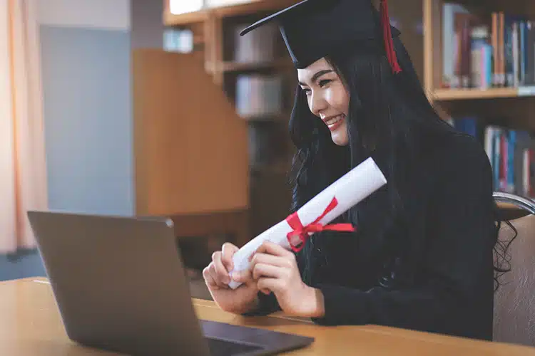 a female student celebrating her graduation virtually