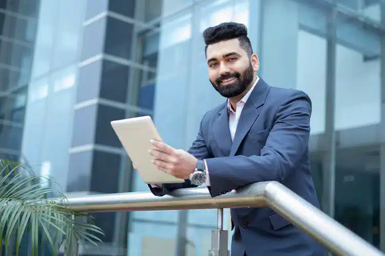 a male office manager working on his tablet