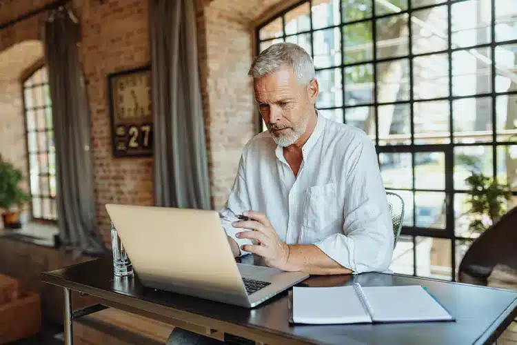 a senior male remote worker earning his college degree online