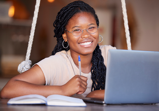 a female college student happy having enrolled at an online school