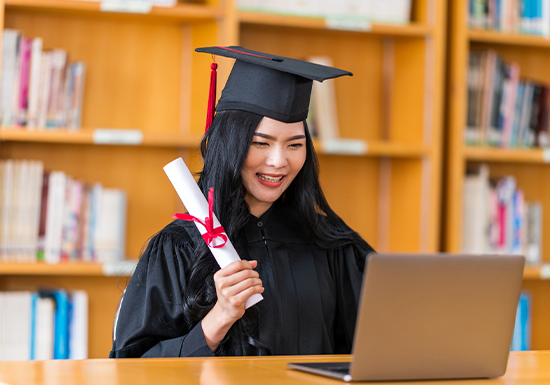 a female college graduate celebrating finishing her 2-year degree program
