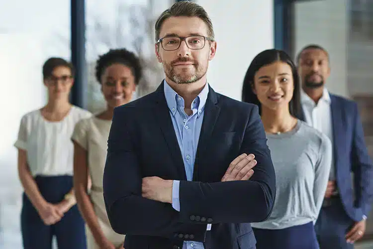 a groupd of corporate managers standing and posing together