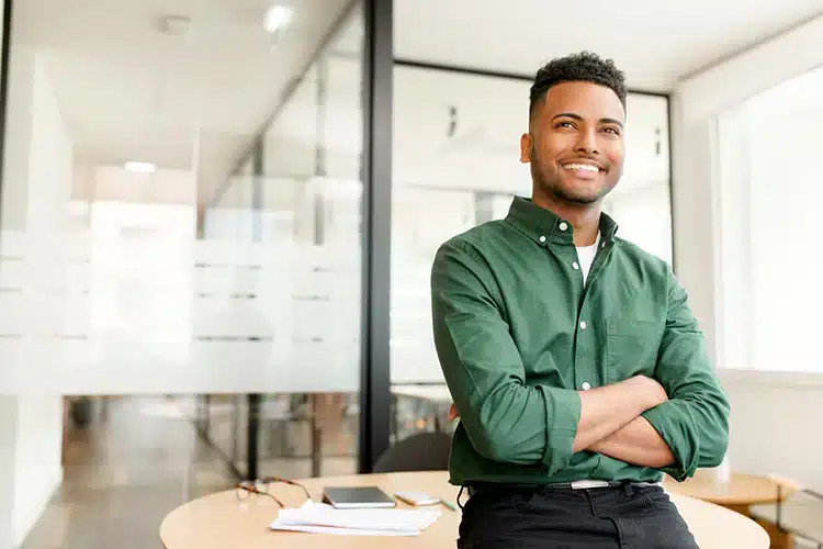 a male IT engineer seated at his work desk