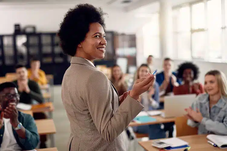 a female educator explaining transformative learning theory in a classroom