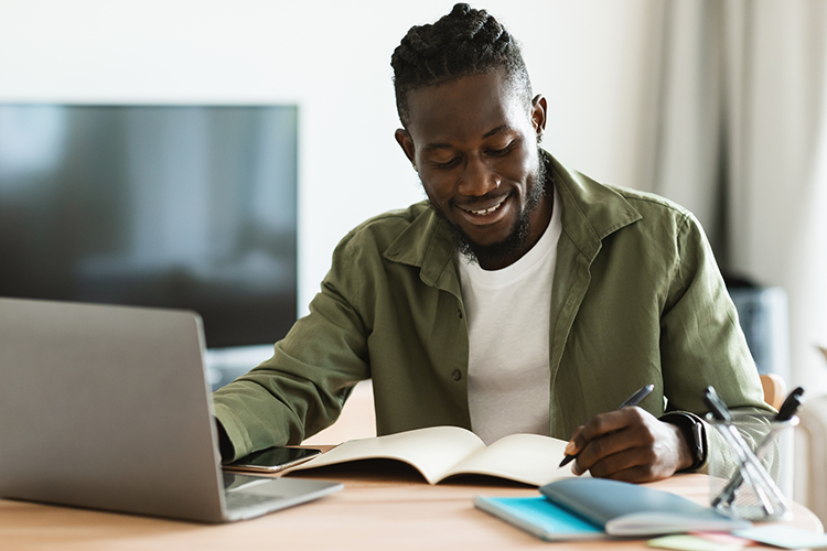 a male college student working on his online assignment