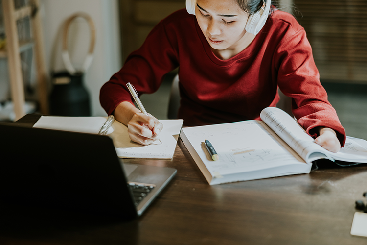 a female bachelor's degree student working on a college assignment