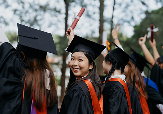 a female graduate celebrating her bachelor's degree