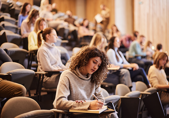 students seated in a large classroom, prepping for the SAT exam