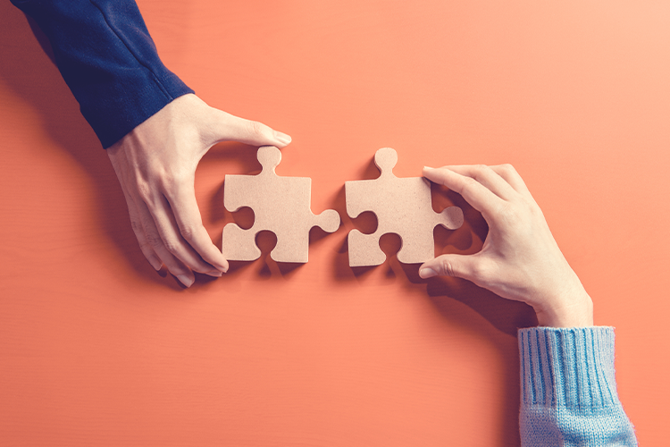 two hands holding puzzle blocks