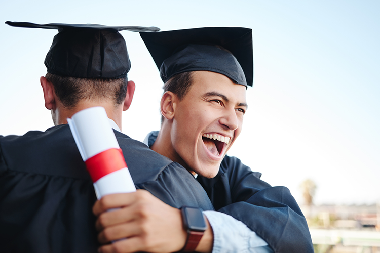 two male master's degree students celebrating their graduation