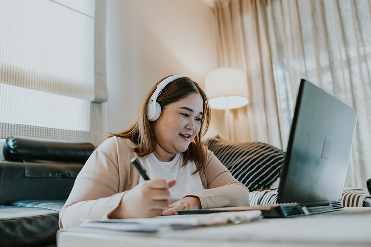 a female online master's degree student attending a lecture