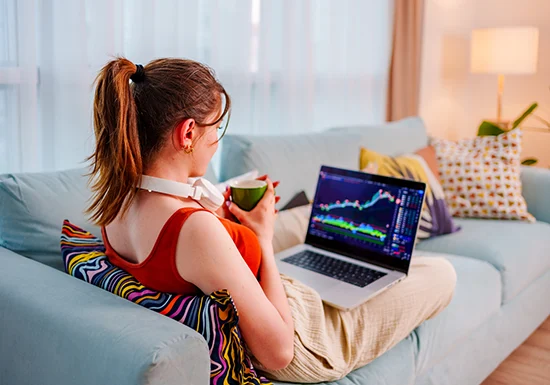 a female IT programmer working on her laptop from the comfort of her home