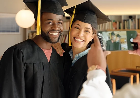 college level certificate holders posing together with graduation caps on