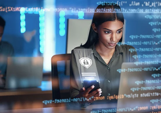 a female cybersecurity professional working on her laptop