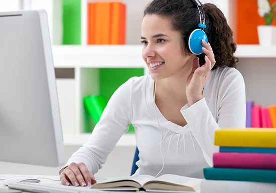 a female student learning via the auditory medium in an online college class